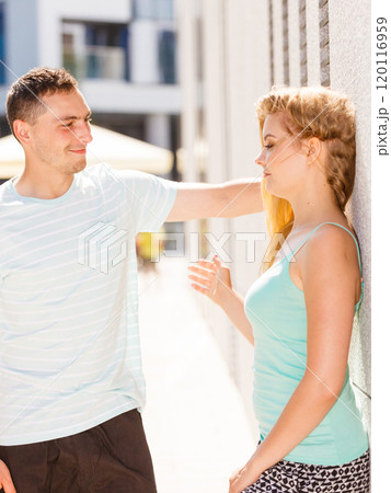 Man flirting with girl on city street 120116959