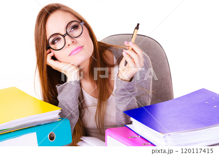 Woman sitting at desk in office and thinking 120117415