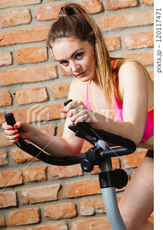 Active woman doing sport biking. 120117471