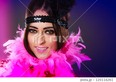 Girl pink plume and black feather on head. Carnival. 120118261