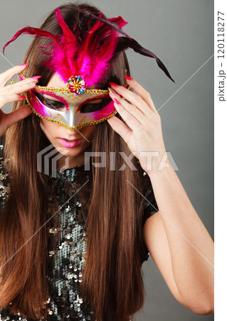 woman face with carnival mask on gray 120118277