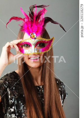 woman face with carnival mask on gray woman face with carnival mask on gray 120118279