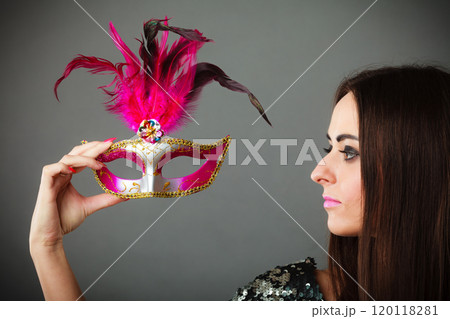 woman holding carnival mask in hand woman holding carnival mask in hand 120118281