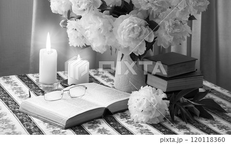Book near a bouquet of flowers Book near a bouquet of flowers 120118360