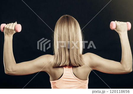Fitness sporty girl lifting weights back view Fitness sporty girl lifting weights back view 120118656