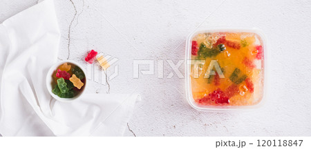Marmalade candies are infused in lemonade for subsequent freezing top view web banner 120118847