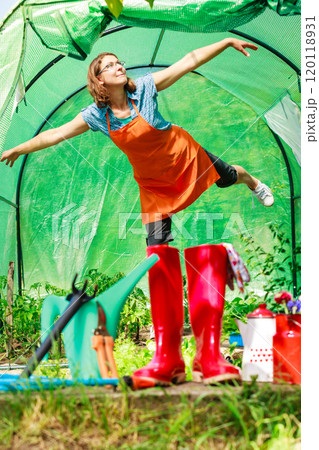 Female farmer and gardening tools in garden 120118931