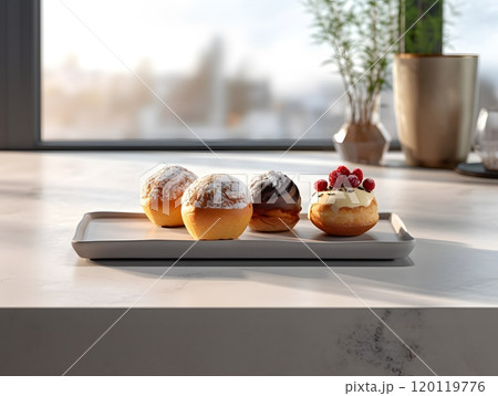 Assorted gourmet pastries on modern kitchen counter with scenic window view 120119776