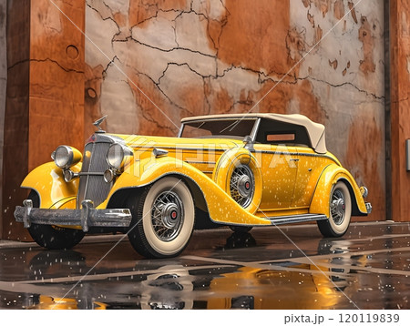 Vintage yellow convertible car in front of rustic wall 120119839