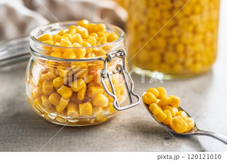 Canned sweet corn in jar on kitchen table. Canned sweet corn in jar on kitchen table. 120121010