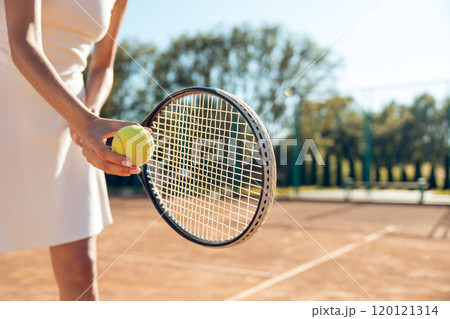 Female tennis player in white clothes exercising on the tennis courts 120121314