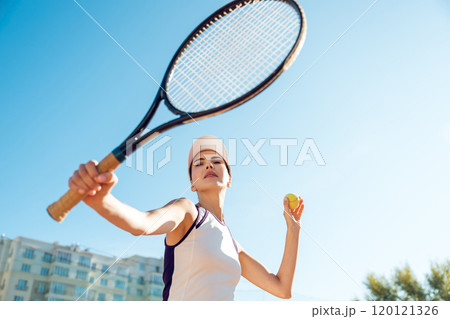 Waist up of a female tennis player hitting the ball 120121326