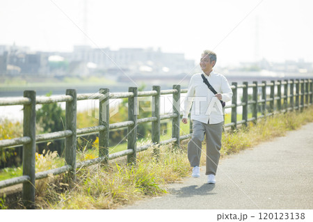土手を元気にウォーキングするシニア   土手を元気にウォーキングするシニア   120123138