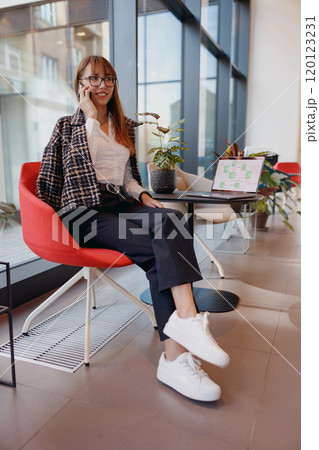 A Trendy Professional Working in a Modern Office Environment, Exuding Style and Comfort A Trendy Professional Working in a Modern Office Environment, Exuding Style and Comfort 120123231