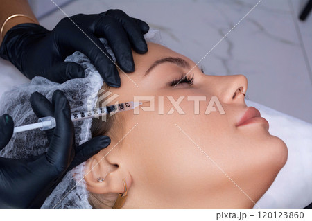 A beautician gives a woman a Botox injection. A procedure for beauty and rejuvenation. 120123860