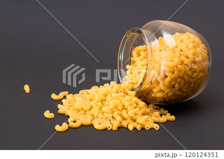 Uncooked Chifferi Rigati Pasta in Glass Jar on Black Background Uncooked Chifferi Rigati Pasta in Glass Jar on Black Background 120124351