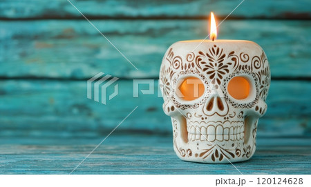 A decorative skull candle illuminated against a rustic wooden backdrop A decorative skull candle illuminated against a rustic wooden backdrop 120124628