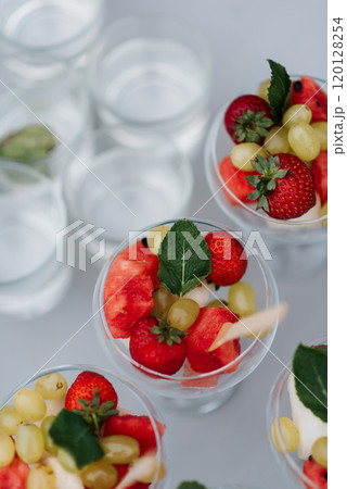 This is a close up shot of a bowl filled with assorted fruit placed on a table 120128254