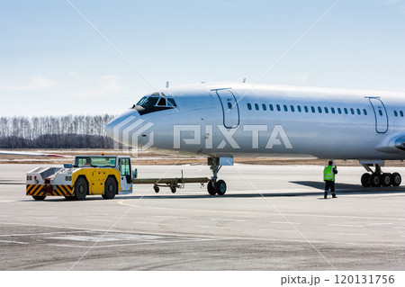 The tractor is towing the passenger airplane 120131756