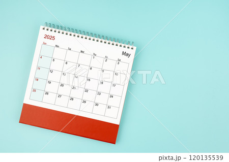 May 2025 desk calendar on blue background for your appointment. 120135539