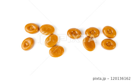 Caramel candies isolated, toffee caramel, round hard milk confectionery, brown sugar candies, small sweets 120136162