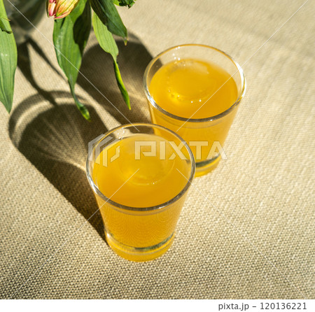 Passion fruit cold drink, welcome drinks set, yellow iced tea, fruit cocktails in small glass with ice on restaurant table Passion fruit cold drink, welcome drinks set, yellow iced tea, fruit cocktails in small glass with ice on restaurant table 120136221