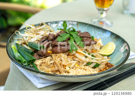 Pad thai, phat thai, or phad tha asian noodles, chinese rice pasta with meat in thailand restaurant table Pad thai, phat thai, or phad tha asian noodles, chinese rice pasta with meat in thailand restaurant table 120136980