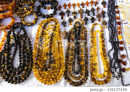 Amber stones market, polished orange gemstones closeup, natural Baltic amber gems jewelry store 120137249