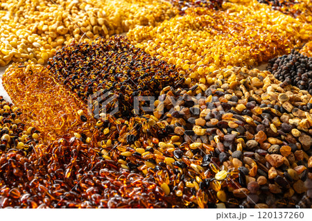 Amber stones market, polished orange gemstones closeup, natural Baltic amber gems jewelry store 120137260