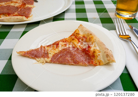 Pepperoni Pizza on Restaurant Plate, Salami Pizza with Olives, Tomatoes and Mozzarella Cheese 120137280