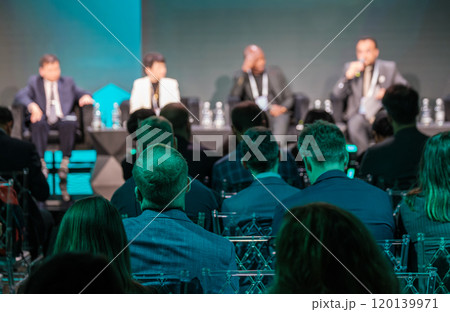 Business conference audience listening to panel discussion 120139971