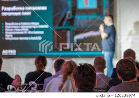 Business professional delivering a presentation at a technology conference Business professional delivering a presentation at a technology conference 120139974