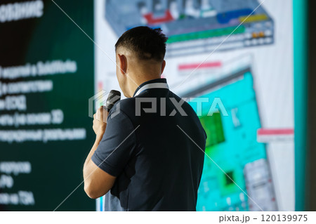 Businessman giving presentation with projected screen background Businessman giving presentation with projected screen background 120139975