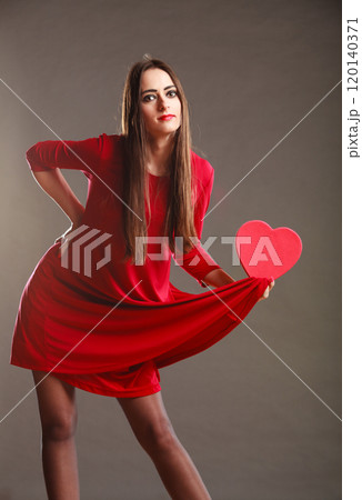 Woman red dress holds heart shaped box Woman red dress holds heart shaped box 120140371