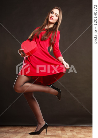 Woman holding heart in red dress. Woman holding heart in red dress. 120140372