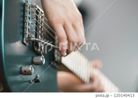 Close up of man playing on electric guitar Close up of man playing on electric guitar 120140413