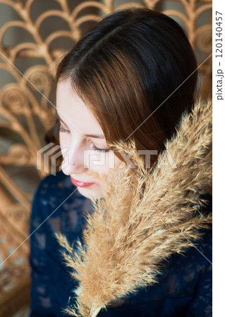 teenage girl in a dress in a romantic location with dry reed stalks teenage girl in a dress in a romantic location with dry reed stalks 120140457