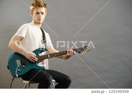 Man playing on electric guitar Man playing on electric guitar 120140509