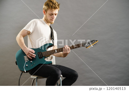Man playing on electric guitar Man playing on electric guitar 120140513