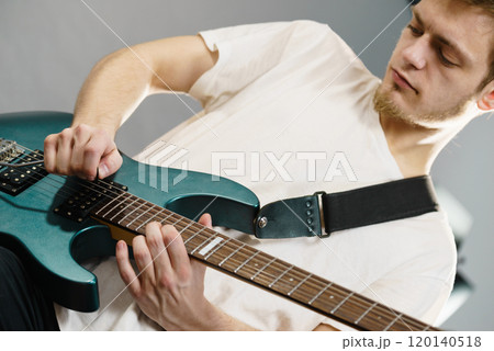 Man playing on electric guitar Man playing on electric guitar 120140518