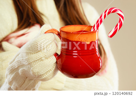 Girl hands holding mug and cane. Girl hands holding mug and cane. 120140692