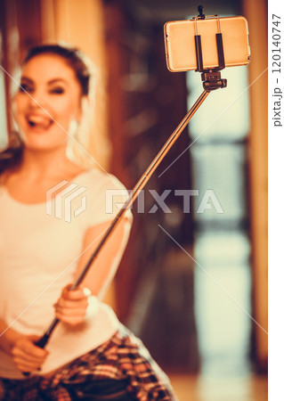 Happy cute girl taking photo with selfie stick. Happy cute girl taking photo with selfie stick. 120140747