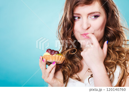 Smiling cute woman holds fruit cake in hand Smiling cute woman holds fruit cake in hand 120140760
