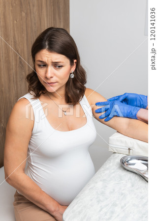 Pregnant Woman Receiving Vaccine with Concerned Expression 120141036