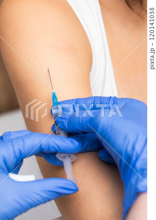 Patient receiving vaccine injection from nurse close-up Patient receiving vaccine injection from nurse close-up 120141038