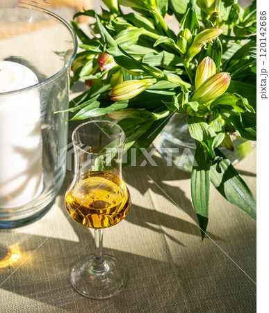 Amaretto almond liquor, sweet alcohol drink, brown Italian liquor made from apricot kernels, on summer table Amaretto almond liquor, sweet alcohol drink, brown Italian liquor made from apricot kernels, on summer table 120142686