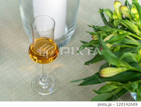 Amaretto almond liquor, sweet alcohol drink, brown Italian liquor made from apricot kernels, on summer table Amaretto almond liquor, sweet alcohol drink, brown Italian liquor made from apricot kernels, on summer table 120142689