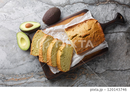 Freshly baked diet avocado bread close-up on wooden board. Horizontal top view Freshly baked diet avocado bread close-up on wooden board. Horizontal top view 120143746
