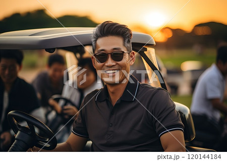 A happy man of Asian appearance is elegantly dressed against the background of a golf cart. 120144184