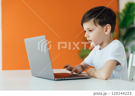 Boy Learning Online With A Laptop At A Table At Home 120144223